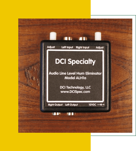 DCI Specialty audio line level hum eliminator device on a wooden surface.